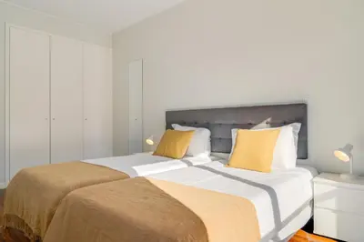 a bedroom with two beds with yellow pillows at Villa Nogueira V with Private Pool by Holiday Rental Madeira in Funchal