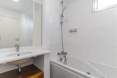 a white bathroom with a sink and a shower at Villa Nogueira V with Private Pool by Holiday Rental Madeira in Funchal