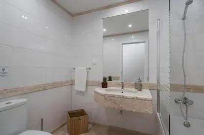 a bathroom with a toilet and a sink and a shower at Solar da Fontinha by An Island Apart in Santa Cruz