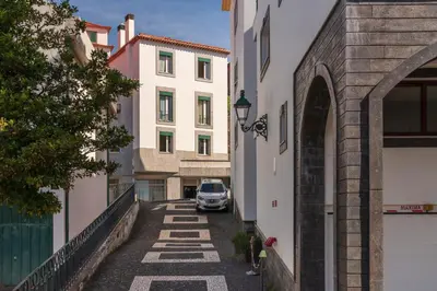 a car parked in a alley between buildings at Solar da Fontinha by An Island Apart in Santa Cruz