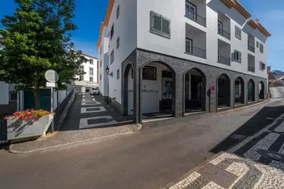 an empty street in front of a white building at Solar da Fontinha by An Island Apart in Santa Cruz