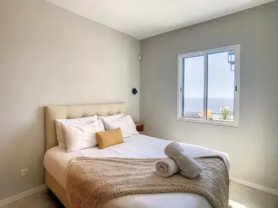 a bedroom with a bed with a window at Avocado Villa by LovelyStay in Funchal