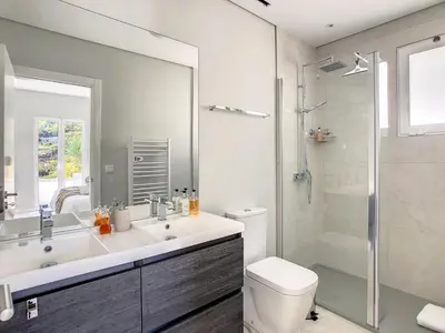 a bathroom with a sink and a toilet and a shower at Avocado Villa by LovelyStay in Funchal