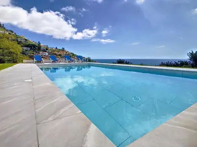 a swimming pool with a view of the ocean at Avocado Villa by LovelyStay in Funchal