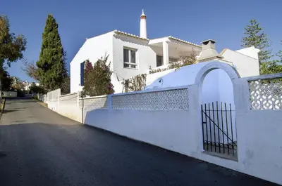 a white fence in front of a white house at 602 Casa Alma Mar in Luz