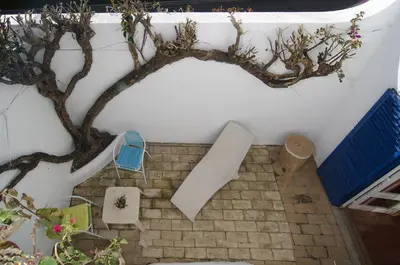 a stairway with a tree and a blue chair at 602 Casa Alma Mar in Luz