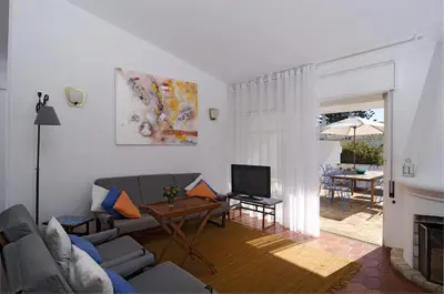 a living room with a couch and a television at 602 Casa Alma Mar in Luz