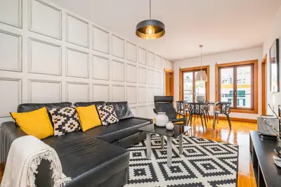 a living room with a black couch and yellow pillows at Apartamento Centralis by Homie in Funchal