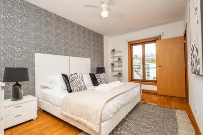 a bedroom with a large white bed and a window at Apartamento Centralis by Homie in Funchal