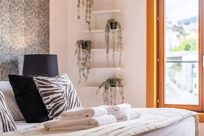 a living room with a white couch and a window at Apartamento Centralis by Homie in Funchal
