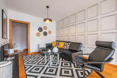 a living room with a couch and a table and chairs at Apartamento Centralis by Homie in Funchal
