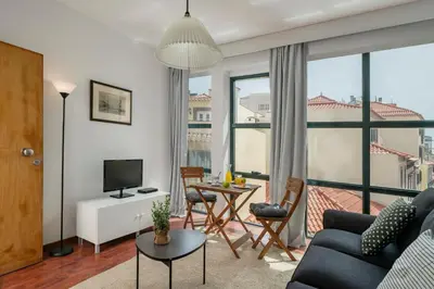 a living room with a couch and a table with chairs at Pelourinho Apartments by An Island Apart in Funchal