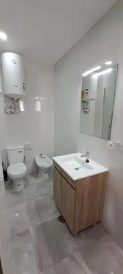 a bathroom with a sink and a toilet and a mirror at Seaview Apartment 100m from beach in Luz