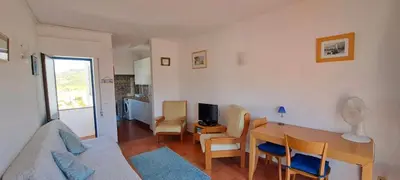a living room with a table and a couch at Seaview Apartment 100m from beach in Luz