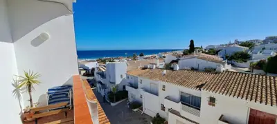 a view of a town with white buildings and the ocean at Seaview Apartment 100m from beach in Luz