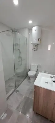 a bathroom with a shower and a toilet and a sink at Seaview Apartment 100m from beach in Luz