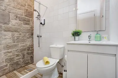 a bathroom with a white toilet and a sink at Funchal Boa Nova Apartment in Funchal