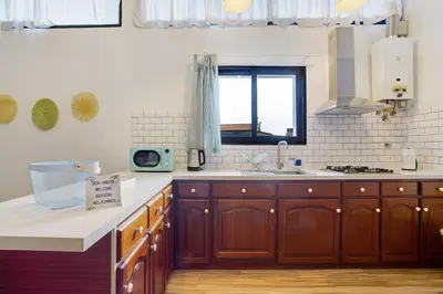 a kitchen with wooden cabinets and a window at Funchal Boa Nova Apartment in Funchal