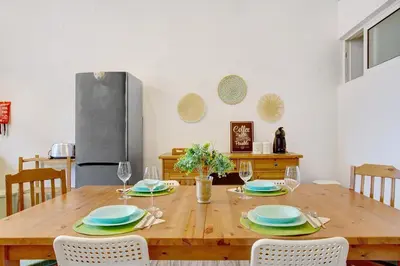 a dining room with a wooden table with chairs at Funchal Boa Nova Apartment in Funchal