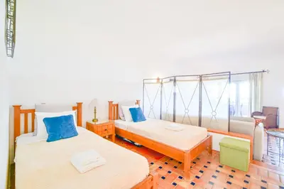 a bedroom with two beds and a couch at Apartment Luz Views by MOJE Holiday in Luz
