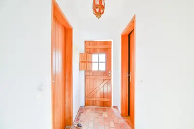 a hallway with a wooden door and a chandelier at Apartment Luz Views by MOJE Holiday in Luz