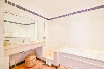 a bathroom with a tub and a sink and a mirror at Apartment Luz Views by MOJE Holiday in Luz