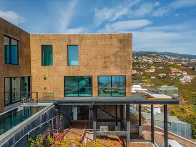 a building with a view of a city at House of Cork and Ivy - By WeHost in Câmara de Lobos