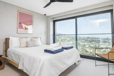 a bedroom with a bed and a large window at House of Cork and Ivy - By WeHost in Câmara de Lobos