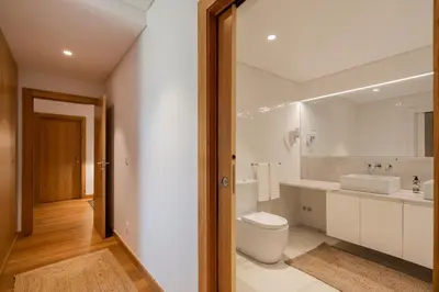 a white bathroom with a toilet and a sink at CASA DO MIRADOURO 6 by Heart of Funchal in Funchal