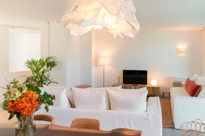 a living room with a white couch and a chandelier at CASA DO MIRADOURO 6 by Heart of Funchal in Funchal
