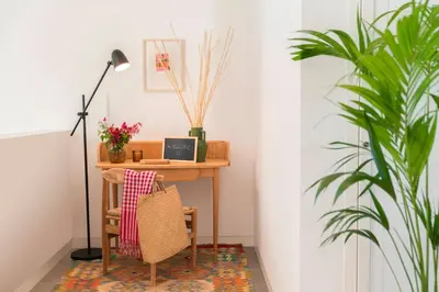 a desk with a chair and a table with a plant at CASA DO MIRADOURO 6 by Heart of Funchal in Funchal