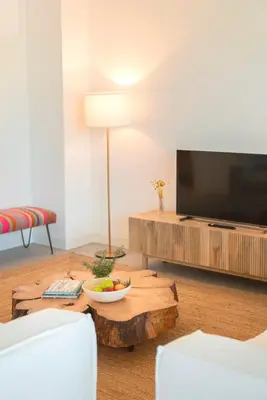 a living room with a coffee table and a flat screen tv at CASA DO MIRADOURO 6 by Heart of Funchal in Funchal