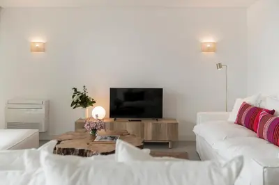 a living room with a white couch and a tv at CASA DO MIRADOURO 5 by Heart of Funchal in Funchal