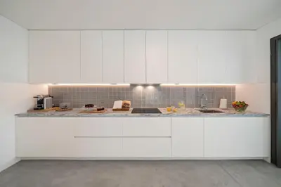 a kitchen with white cabinets and a counter top at CASA DO MIRADOURO 5 by Heart of Funchal in Funchal