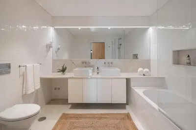 a white bathroom with a tub and a toilet and a sink at CASA DO MIRADOURO 5 by Heart of Funchal in Funchal