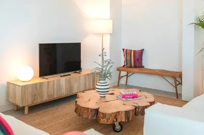 a living room with a wooden coffee table with a television at CASA DO MIRADOURO 7 by Heart of Funchal in Funchal