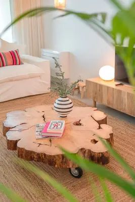 a living room with a tree stump coffee table at CASA DO MIRADOURO 7 by Heart of Funchal in Funchal