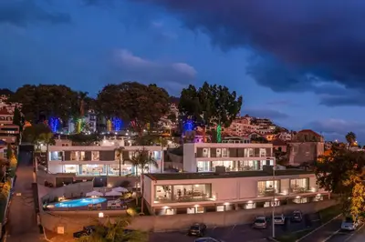 a view of a building at night with a city at CASA DO MIRADOURO 7 by Heart of Funchal in Funchal