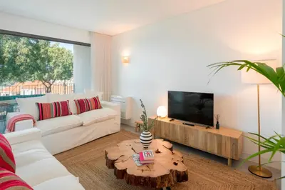 a living room with a white couch and a tv at CASA DO MIRADOURO 7 by Heart of Funchal in Funchal