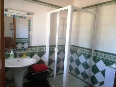 a bathroom with a shower and a sink at Chambres Guest house in Bensafrim