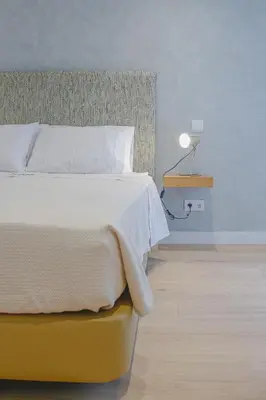a bedroom with a bed and a lamp on a table at Casal da Penha Apartments in Funchal