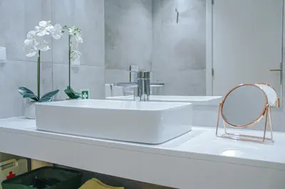 a bathroom with a white sink and a mirror at Casal da Penha Apartments in Funchal
