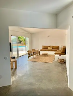 a living room with a couch and a table at Casa 70 - Surfboard included in Aljezur