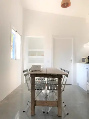 a table with a laptop on it in a room at Casa 70 - Surfboard included in Aljezur
