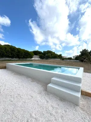 a swimming pool with a staircase and a swimming poolvisorvisor at Casa 70 - Surfboard included in Aljezur