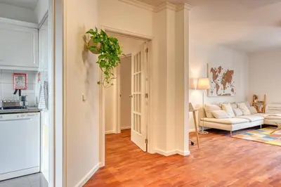 a kitchen and a living room with a couch at Encarnação Funchal, a Home in Madeira in Funchal