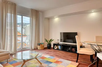 a living room with a television and a table at Encarnação Funchal, a Home in Madeira in Funchal