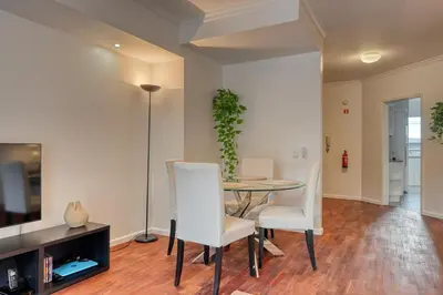 a dining room with a table and white chairs at Encarnação Funchal, a Home in Madeira in Funchal