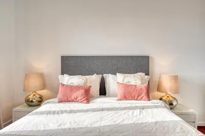 a bedroom with a large bed with pink pillows at Encarnação Funchal, a Home in Madeira in Funchal