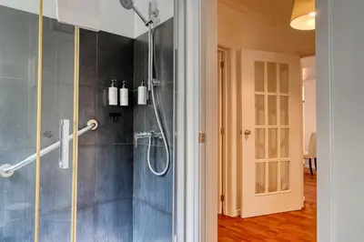 a bathroom with a shower and a glass door at Encarnação Funchal, a Home in Madeira in Funchal